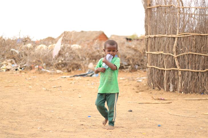A 7 Year Old Internally Displaced Boy With Hand Water Bottle Heading To The Berkad (Water Storage) To Quench His Thirst In Daif IDP Camp, Kismayo On November 2022